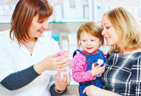 adult woman with a kid talking to a pharmacist
