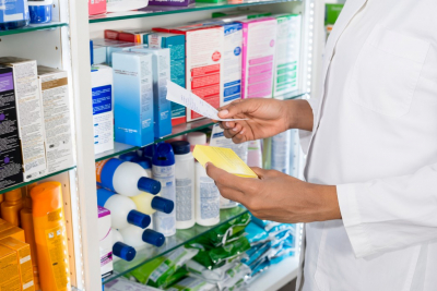 female pharmacist looking at a prescription